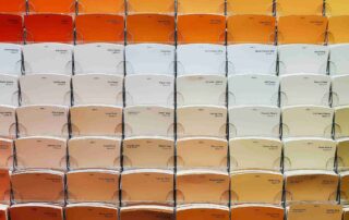 Color Psychology: An array of paint swatches in various shades of orange, yellow, and neutral colors, demonstrating a wide selection of hues for home decor.